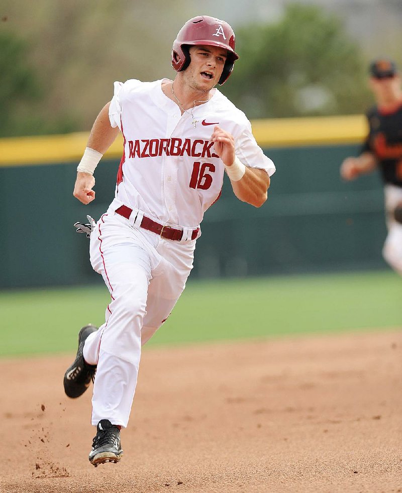 Andrew Benintendi of Arkansas heads to third base in Fayetteville in this April file photo.