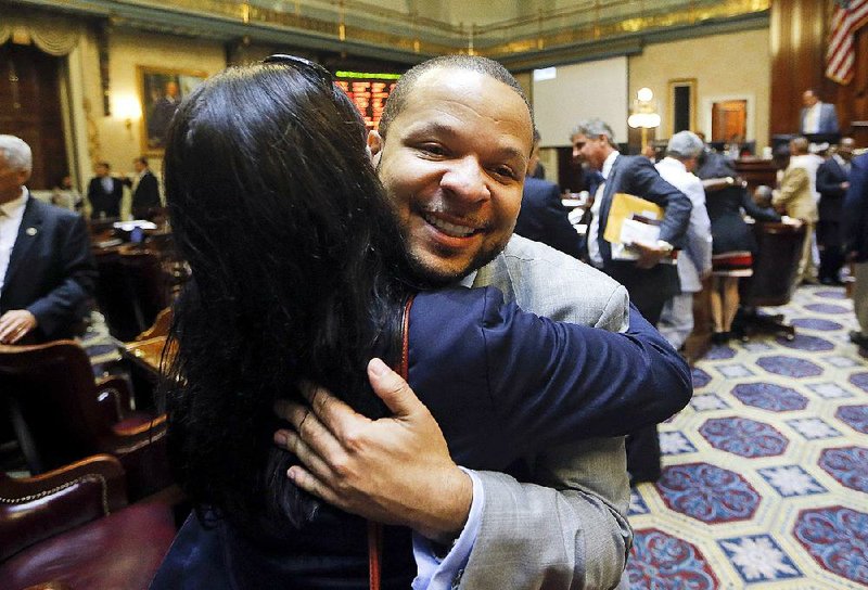 Democratic state Rep. John King celebrates after the House approved a bill early Thursday to remove the Confederate flag from the Capitol grounds in Columbia, S.C.