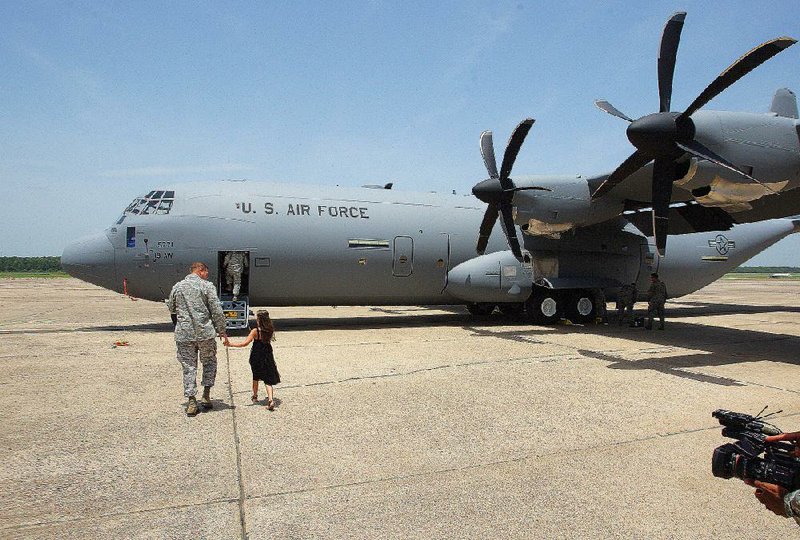 Col. Dan Lockert takes his daughter Rebekah Lockert, 8, on a tour of the new C-130 J-model cargo plane Thursday at Little Rock Air Force Base in Jacksonville. Lockert served as the delivery officer, commanding the crew that delivered the C-130J to the base from the factory in Georgia.