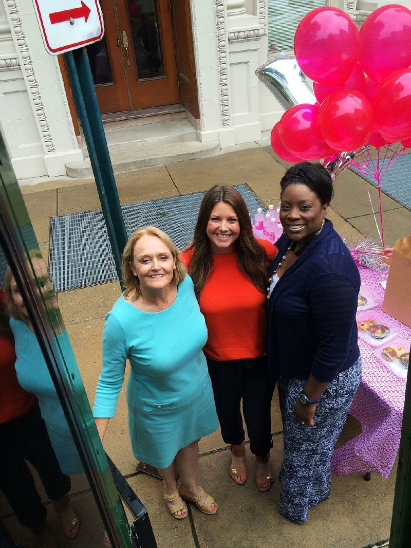 Susan G. Komen Arkansas executive director Sherrye McBryde, special events director Jessie Gillham and mission director Kanisha Caesar are shown at a trolley stop along Capitol Avenue on June 18. Little Rock’s Komen walk is the second biggest in the country, behind Columbus, Ohio’s.