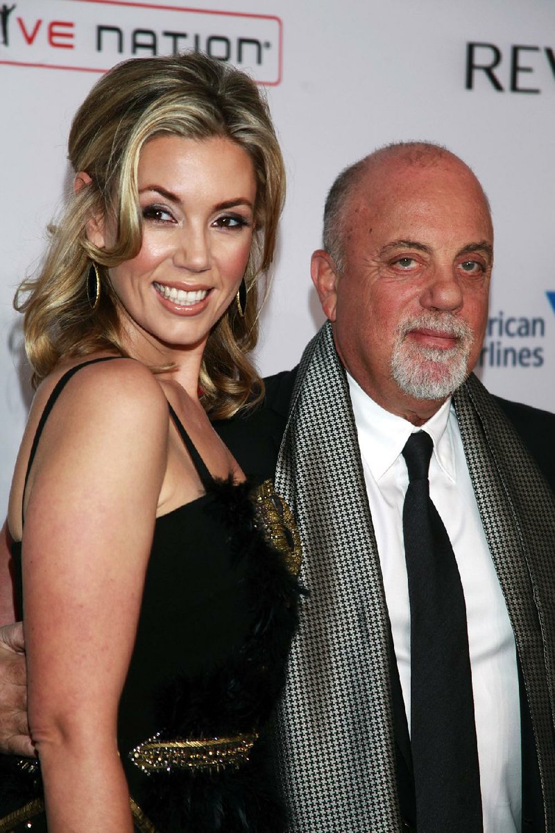 In this Oct. 15, 2013 file photo, Alexis Roderick, left, and Billy Joel arrive at the Elton John AIDS Foundation's 12th Annual "An Enduring Vision" benefit gala in New York. Joel married girlfriend Alexis Roderick in a surprise ceremony at the coupleís annual July 4 party. 