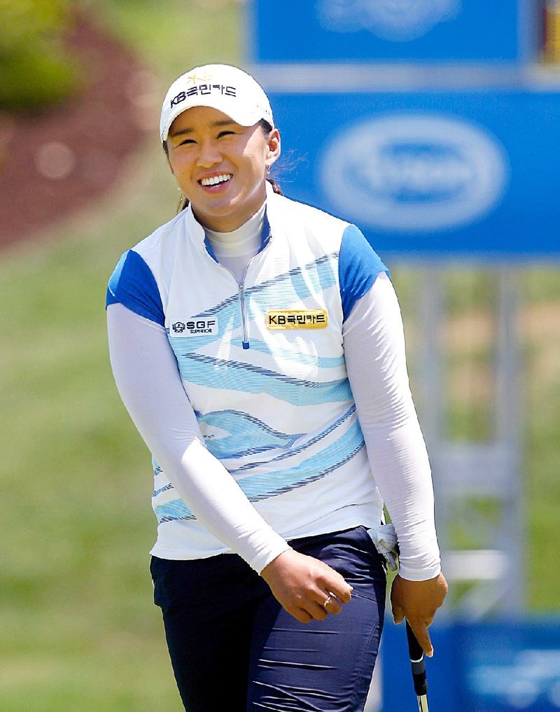 Amy Yang flashes a smile after finishing on the 18th green during the first round of the Wal-Mart NW Arkansas Championship at Pinnacle Country Club in Rogers on Friday, June 29, 2012.
