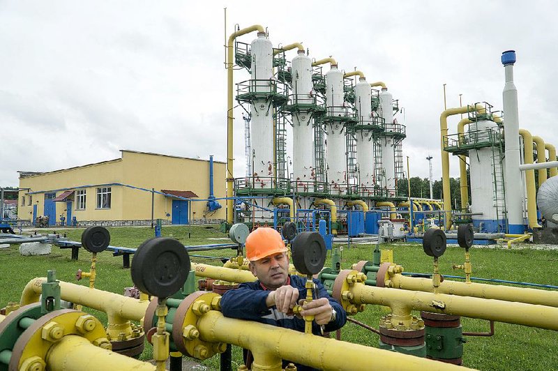A Ukr TransGaz employee adjusts a pressure gauge at the Dashava underground natural gas storage facility in Ukraine in May. Pipelines crossing Ukraine help supply the European Union with Russian natural gas.
