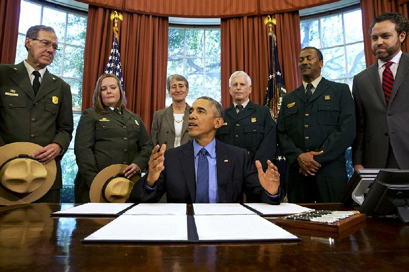 President Barack Obama speaks Friday in the Oval Office after designating three new national monuments, in California, Nevada and Texas, and preserving millions of acres that are home to prehistoric rock carvings, mammoth bones and popular scenic destinations. “All of them speak to some incredible history,” Obama said. At the signing were National Park Service and other Department of Interior officials, including Interior Secretary Sally Jewell (third from left). 