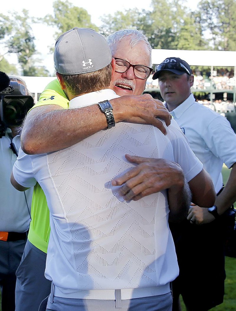 Jordan Spieth hugs his grandfather Bob Julius after shooting a 61 in the third round of the John Deere Classic to take a two-shot lead over Danny Lee. 