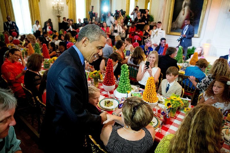 President Barack Obama makes an appearance Friday in the East Room of the White House at a dinner for the winners of the Healthy Lunchtime Challenge, including Aspen Smith, 11, of Little Rock.