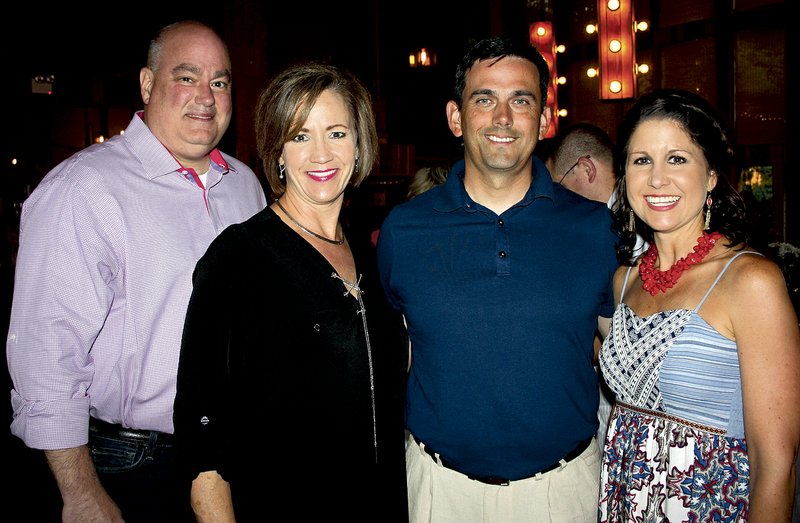 Tim and Mary Beth Brooks (from left) visit with James and Angie Graves at the 11th annual Red, White and Baby Blue event June 26 at The Garden Room in Fayetteville