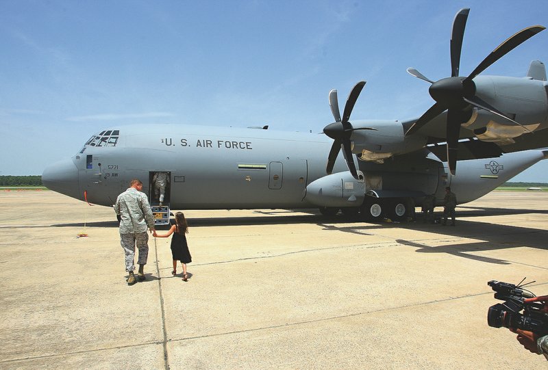 Arkansas Democrat-Gazette/STEPHEN B. THORNTON Col. Dan Lockert walks his daughter Rebekah Lockert, 8, to tour a new C-130J Hercules cargo plane Thursday at Little Rock Air Force Base in Jacksonville. Lockert served as the delivery officer, commanding the crew bringing the C-130J to the base from the factory in Georgia.