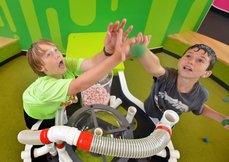 Drew Beckfield (left) and Payne Fox, both 11 and from Bentonville, try out a feature Saturday in the Nickelodeon Play Lab during a special preview event at the Scott Family Amazeum in Bentonville.