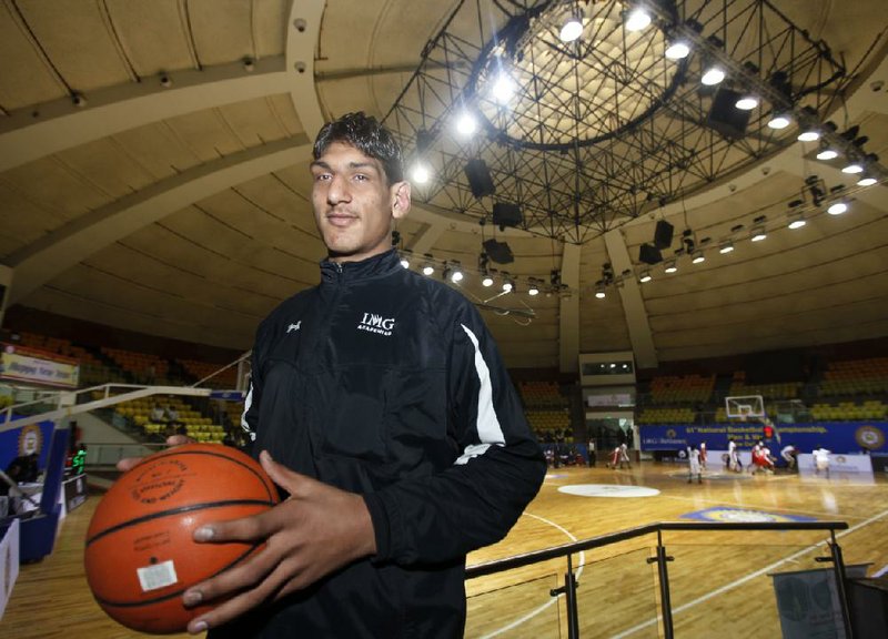 Indian Satnam Singh poses with a basketball at the Talkatora Stadium in New Delhi, India, in this January 2011 file photo.