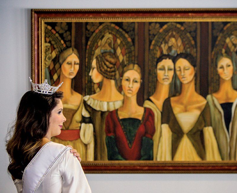 Miss Arkansas Loren McDaniel waits outside a meeting room at the Hot Springs Convention Center for her first news conference Sunday in Hot Springs. In the background is a painting by Sue Norton Kent titled "She Dares to be Different."