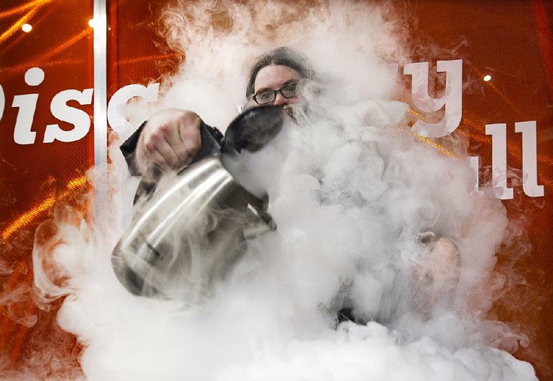 Kevin Delaney vanishes with a foomp! into a cloud that came from the combination of hot water and super-cold liquid nitrogen at the Museum of Discovery in Little Rock.