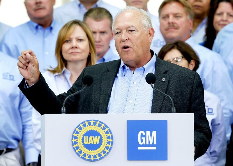 United Auto Workers President Dennis Williams speaks Monday as General Motors CEO Mary Barra (background, left) listens during a ceremony to mark the the start of contract negotiations in Detroit.