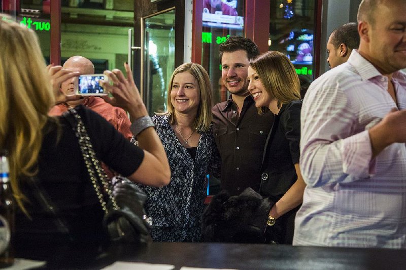 Nick Lachey poses with fans in the Cincinnati bar he opened with his brother Drew.