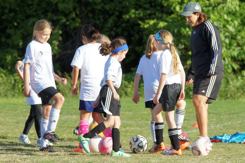 Bentonville girls soccer coach Kris Henry assists with Sporting Arkansas tryouts recently.
