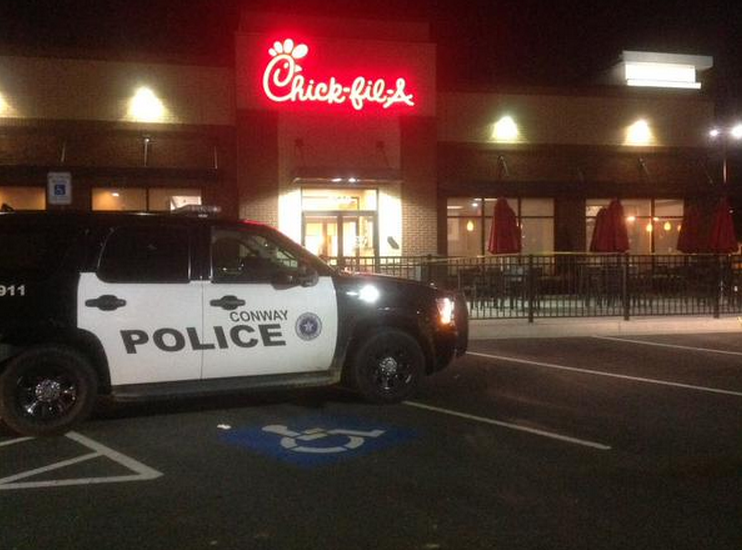 This photograph released by the Conway Police Department shows a police vehicle outside a Chick-fil-A  restaurant were two employees were shot during an attempted robbery.