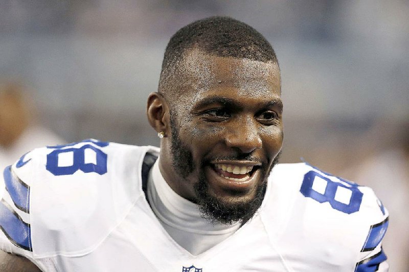 In this Jan. 4, 2015, file photo, Dallas Cowboys wide receiver Dez Bryant (88) talks to his teammates on the sideline during the first half of an NFL wildcard playoff football game against the Detroit Lions in Arlington, Texas. 