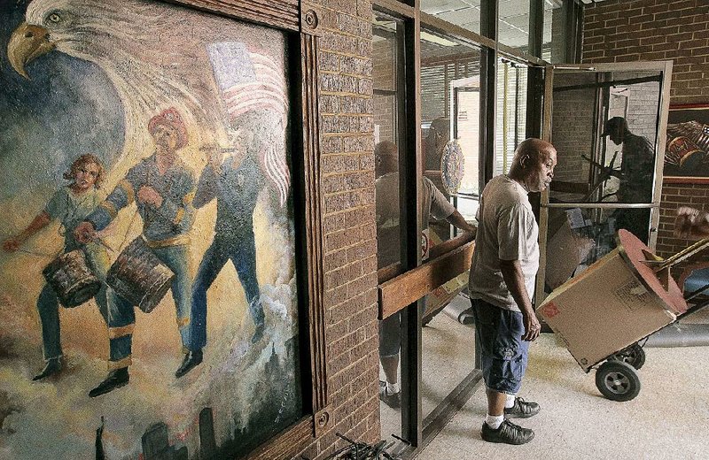 Sammie Clay and other American Legion Post 1 members move office items while vacating their building on East Capitol Avenue in Little Rock for a new building in North Little Rock. 