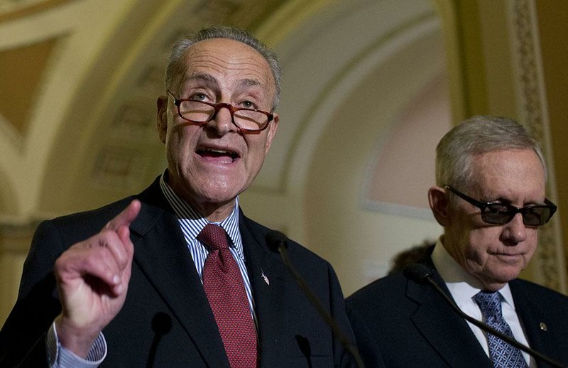 Sen. Charles Schumer, D-N.Y., joined by Senate Minority Leader Sen. Harry Reid of Nev., right, speaks to media after a policy luncheon on Capitol Hill in Washington, Wednesday, July 8, 2015. 