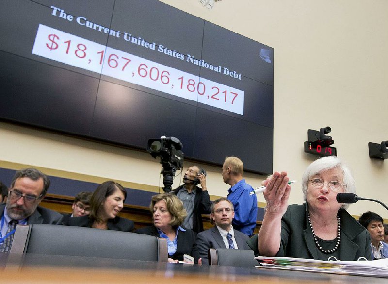 Federal Reserve Chairman Janet Yellen testifies Wednesday on Capitol Hill in Washington. Yellen said the Fed will likely start raising interest rates later this year if the U.S. economy continues to show signs of improvement. 