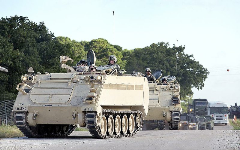 A National Guard convoy heads toward Camp Swift in Bastrop, Texas, on Wednesday. Camp Swift is home base for the Texas part of Operation Jade Helm 15, a seven-state, three-month war exercise.