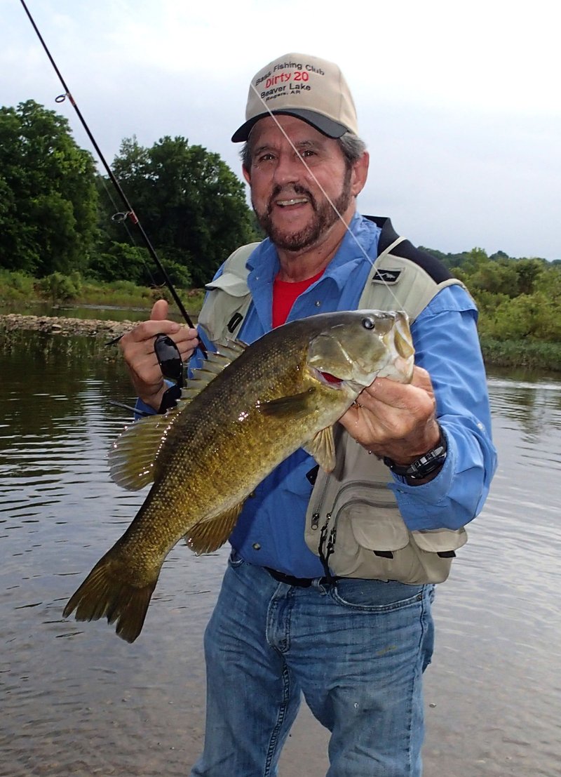 Russ Tonkinson shows one of several smallmouth bass caught July 2 during a Kings River •oat trip. Fish had an appetite for tube baits on the 4.5-mile float.