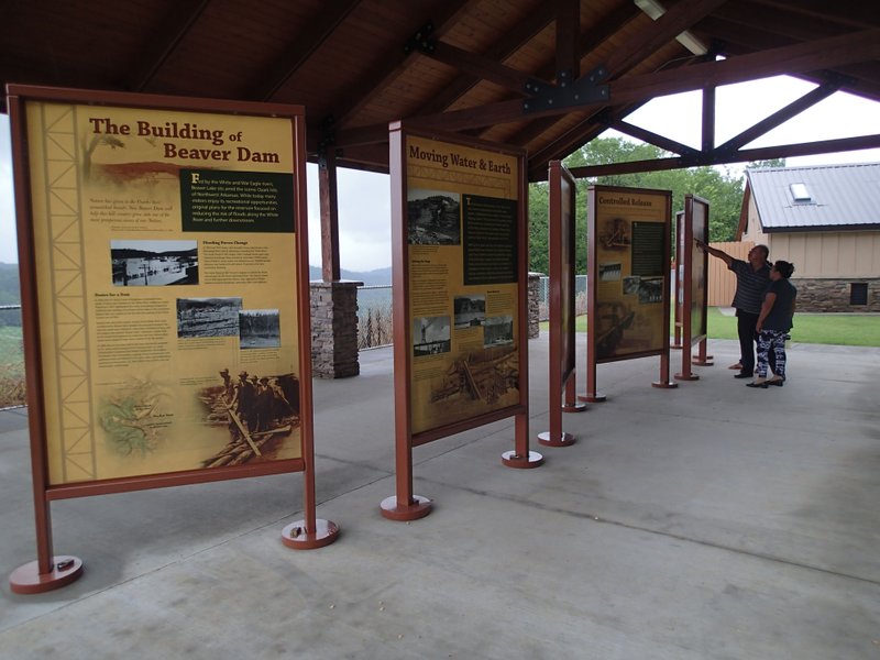 Visitors read information about the building of Beaver Dam July 9 at the overlook on the south end of the dam.