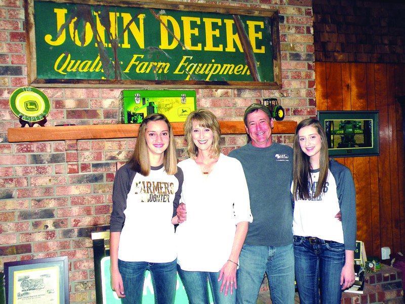 The Shane Kasper family of Atkins is the 2015 Pope County Farm Family of the Year. Family members include, from left, Ainsley, Angela, Shane and Avery. The family raises poultry and cattle on Pea Ridge north of Atkins. Shane is a “huge” collector of John Deere memorabilia.
