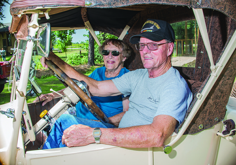 Patty Graham and her husband and current president of the Tin Lizzie Club, Paul, sit inside their 1927 Ford.