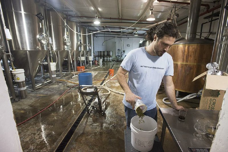 Jesse Gagnon of Fayetteville brews pale ale at Ozark Beer Co. The brewery recently added three 900-gallon barrel tanks, increasing its capacity by 50 percent.