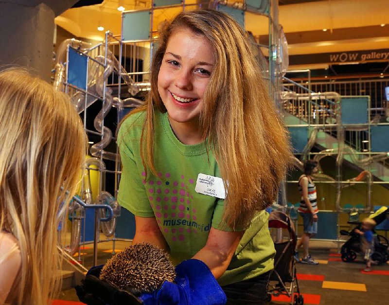 Museum of Discovery volunteer Skye Rippentrop-Pridmore gives a young visitor a close look at the museum’s resident hedgehog, Hugo. Rippentrop-Pridmore won the Arkansas Museums Association’s Outstanding Museum Volunteer of the Year Award for 2015, an honor not limited to school-age volunteers. 