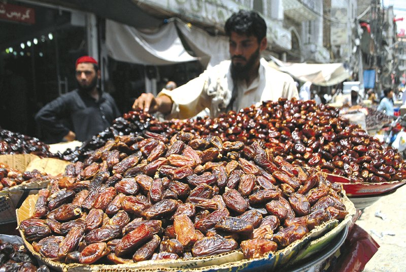 A Pakistani vendor sells dates for Ramadan in Peshawar, Pakistan. Muslims throughout the world marked the month of Ramadan, the holiest month in the Islamic calendar, with dawn to dusk fasting. Custom saw them breaking the fast on Eid al Fitr (Friday at sunset) by eating dates.