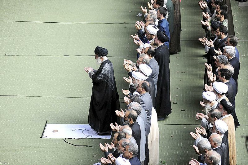 Ayatollah Ali Khamenei (left) leads Eid al-Fitr prayers Saturday at the Imam Khomeini Mosque in Tehran to mark the end of the holy Muslim month of Ramadan. 