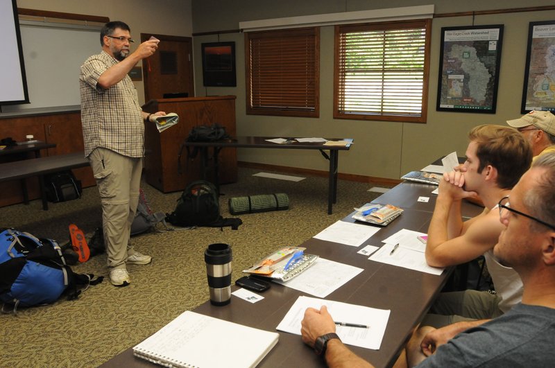 NWA Democrat-Gazette/FLIP PUTTHOFF Scott Branyan of Rogers talks about map and compass navigation Saturday during his presentation on backpacking at Hobbs State Park-Conservation Area near Rogers.