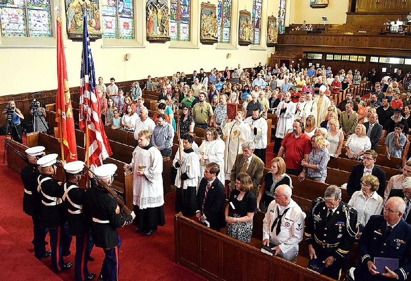 A color guard from the 4th Marine Division stands at the front of the church during a ceremony to honor five fallen servicemen Sunday at The Basilica of Sts. Peter & Paul in Chattanooga, Tenn.