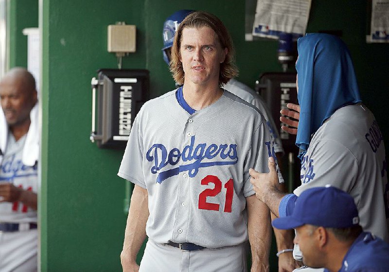 Zack Greinke, starting pitcher with the Los Angeles Dodgers, pauses in the dugout Sunday during a baseball game against the Washington Nationals at Washington.