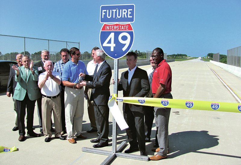 Gov. Asa Hutchinson cuts the ceremonial ribbon opening a 6-mile stretch of Interstate 549, which runs through Chaffee Crossing east of Fort Smith. State officials also attending were Scott Bennett, director of the Highway Department, and Dick Trammel, chairman of the Highway Commission. The highway will connect Arkansas 22 and 59 in Barling with U.S. 71 south of Fort Smith.