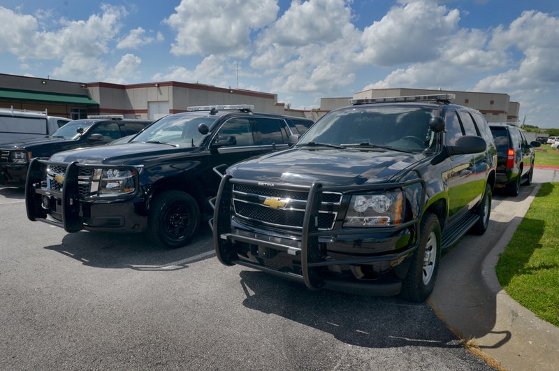 New Chevrolet Tahoe patrol vehicles sit on the lot at the Benton County Sheriff’s Office in Bentonville. The Sheriff’s Office introduced a black Chevrolet Tahoe marked with black and gray when Sheriff Kelley Cradduck was elected in 2012. The markings are subdued, and Cradduck said there is an advantage to having vehicles that aren’t covered in police lights and decals: “The element of surprise keeps everybody safer."