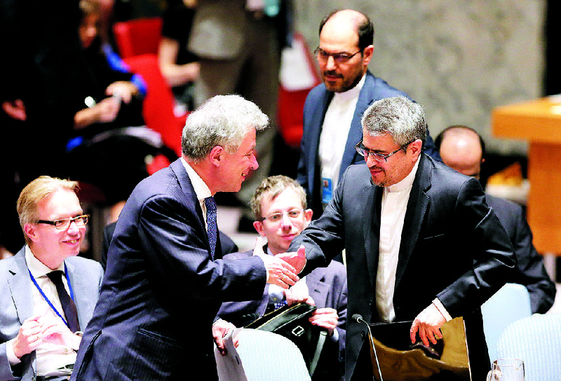 Thomas Mayr-Harting (left), head of the delegation of the European Union to the United Nations, greets Iran’s U.N. ambassador, Gholamali Khoshroo, at U.N. headquarters on Monday. The U.N. Security Council unanimously endorsed the landmark nuclear deal between Iran and six world powers.