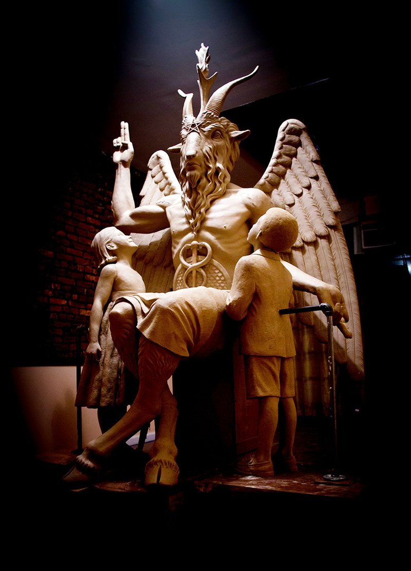 This 2014 photo provided by The Satanic Temple shows a bronze Baphomet, which depicts Satan as a goat-headed figure surrounded by two children. The Satanic Temple, a group advocating the separation of church and state, is proposing that the statue be placed outside the Arkansas Statehouse after their first choice of the Oklahoma Capitol grounds was scuttled in 2015 by a state Supreme Court ruling barring all religious monuments.