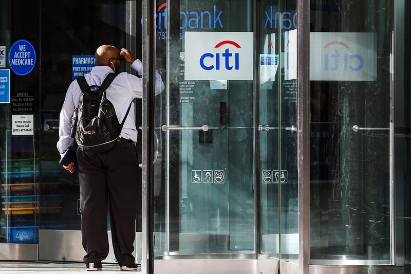 A man peers into a Citigroup Inc. Citibank branch in Los Angeles earlier this month. The bank Tuesday said it has agreed to refund an estimated $700 million to its credit card customers for deceptive marketing, billing and other illegal practices. 