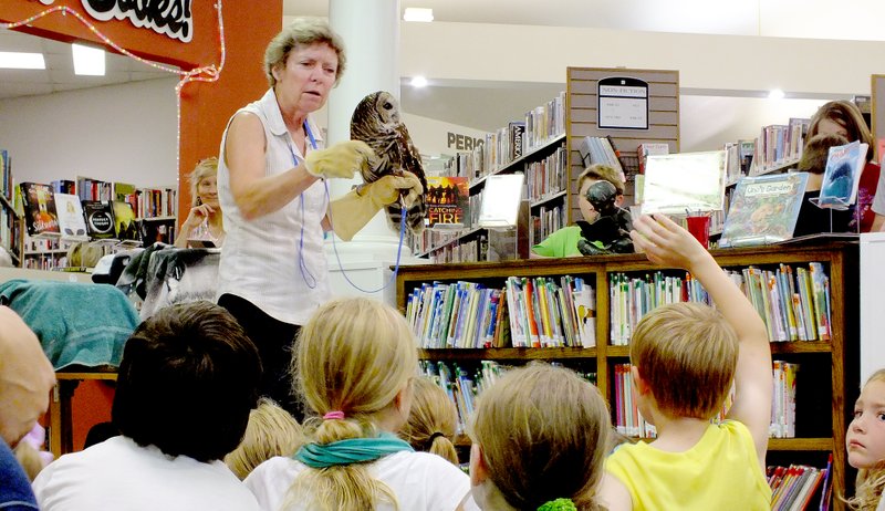 Brandon Howard/The Weekly Vista Lynn Sciumbato, a conservationist with Morning Star Rehabilitation Center in Gravette, takes a question from a youngster Thursday, July 16, at the Bella Vista Public Library. Sciumbato offered a symposium about the importance of conservation and wildlife rehabilitation as part of the library&#x2019;s summer reading program.