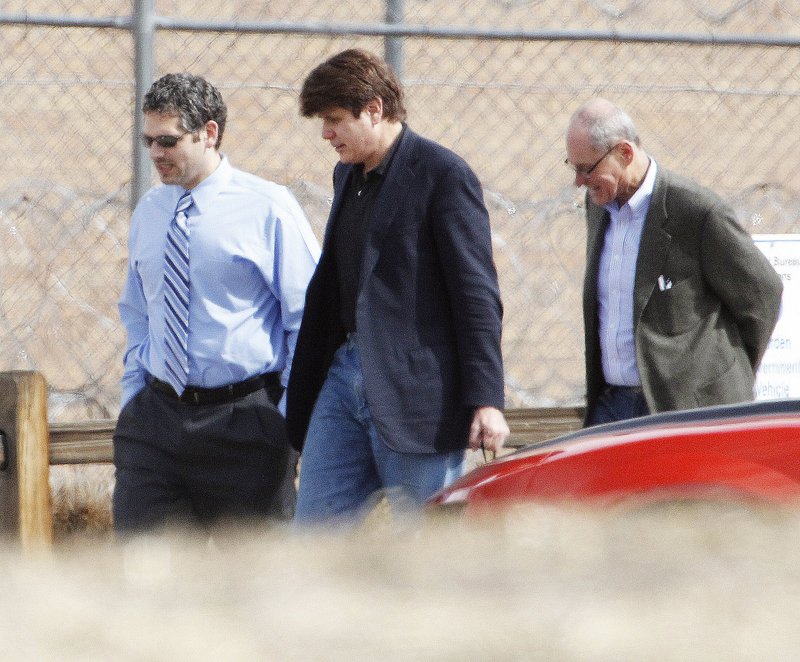 Former Illinois Gov. Rod Blagojevich (center) walks with attorneys as he arrives at the Federal Correctional Institution Englewood in Littleton, Colo., to begin serving his 14-year sentence for corruption on March 15, 2012. The 7th U.S. Circuit Court of Appeals overturned some of his corruption convictions in a ruling released Tuesday.