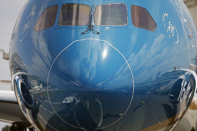 The apron at Le Bourget airport, north of Paris, is reflected in the nose of a Boeing 787 Dreamliner before a demonstration flight at the Paris Air Show in June. Boeing on Wednesday posted a profit of $1.11 billion. 