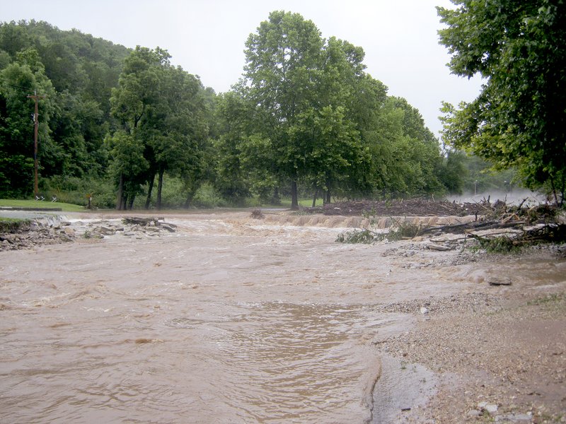 Photos by Missouri Department of Conservation Two photos of the Old CCC Lodge Bridge at Roaring River State Park, taken from approximately the same spot, show how the trout park is returning to normal. The top picture was taken July 7 when flooding swamped the park. The bottom picture was taken on July 10 when the park re-opened. Effective flood-response procedures utilized by Missouri Department of Conservation (MDC) hatchery staff and long hours put in by MDC heavy equipment operators helped trout fishing make a quick recovery at Roaring River.