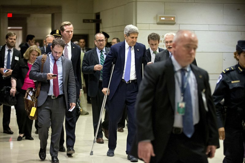 Secretary of State John Kerry, center, leaves a classified briefing for all House members on Capitol Hill, in Washington, Wednesday, July 22, 2015, to head to a Senate briefing to speak about the deal reached to curb Iran's nuclear program in exchange for billions of dollars in relief from international sanctions. 