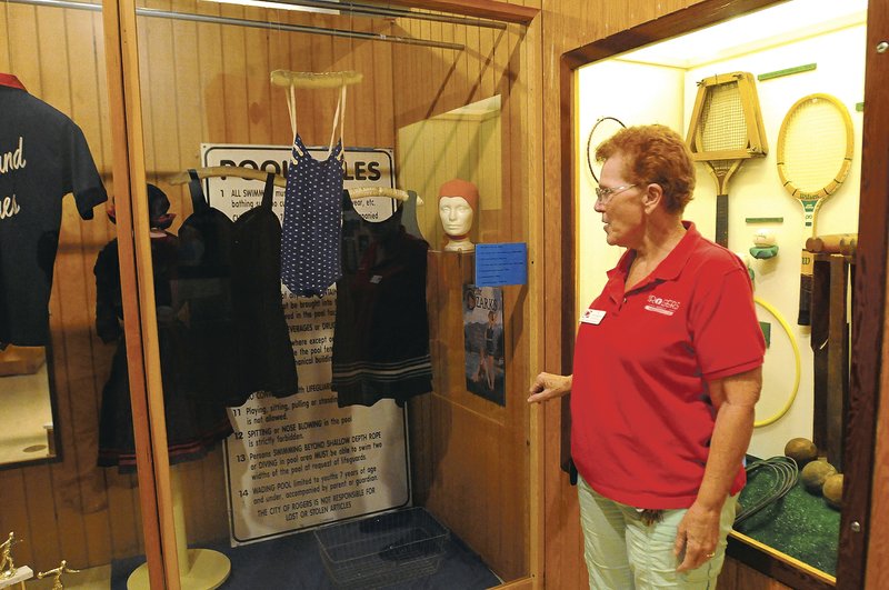 NWA Democrat-Gazette/FLIP PUTTHOFF Pat Campbell with the Rogers Historical Museum shows swim wear that is part of the &#8220;Fun &amp; Games&#8221; exhibit.