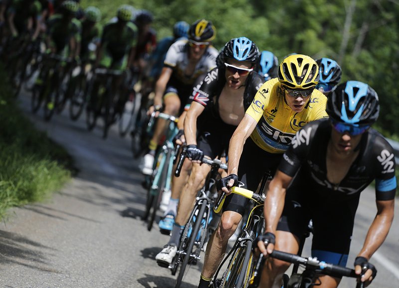 British cyclist Chris Froome (second from right) rides with teammates Richie Porte (right) and Geraint Thomas (third from right) during the 19th stage of the Tour de France on Friday near La Toussuire, France.
