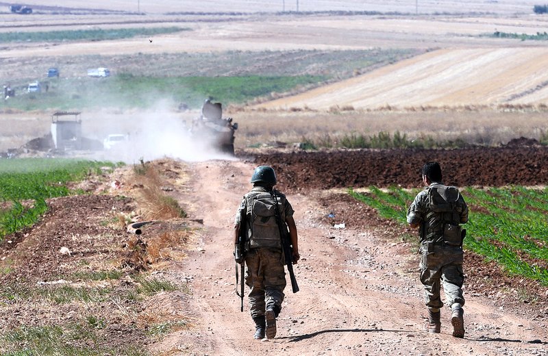 Turkish soldiers patrol Friday outside the village of Elbeyli near the border with Syria in southeastern Turkey. 