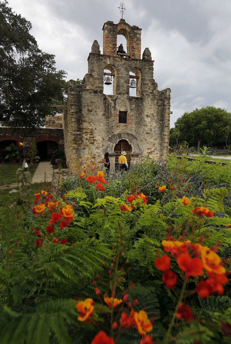 Visitors enter the sanctuary at Mission Espada in San Antonio, one of five San Antonio Missions, which have been awarded world heritage status by the United Nations Educational, Scientific and Cultural Organization’s World Heritage Committee. The Spanish Roman Catholic sites were built in the 18th century in and around the area that today is San Antonio. 